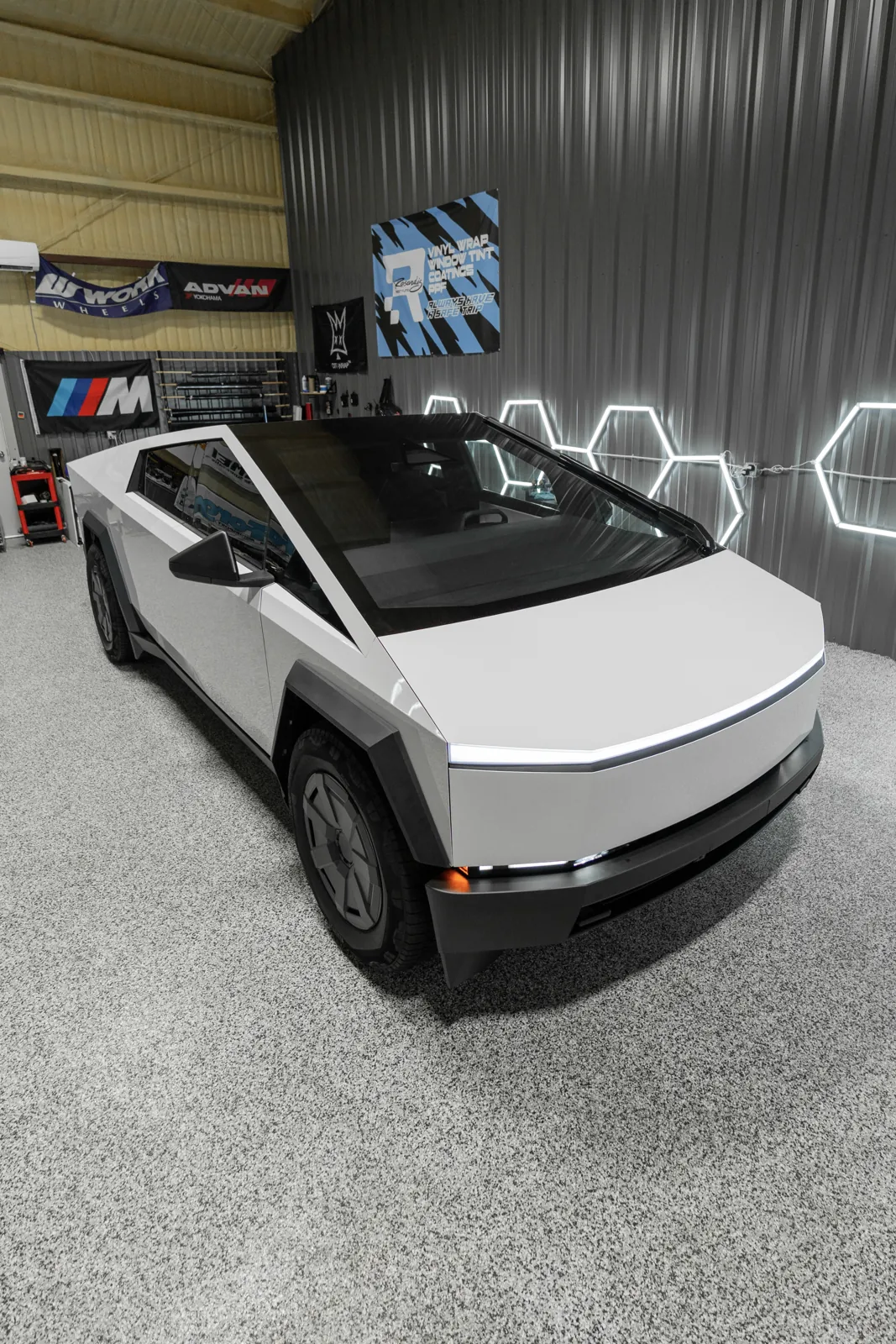 Tesla Cybertruck under hex lights in the Resendiz shop during a color PPF install
