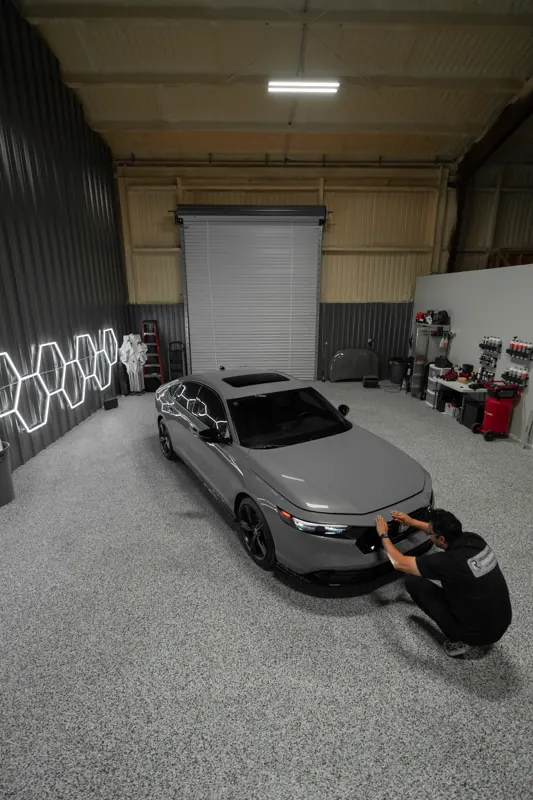 Installer at the Accord side skirt during PPF install